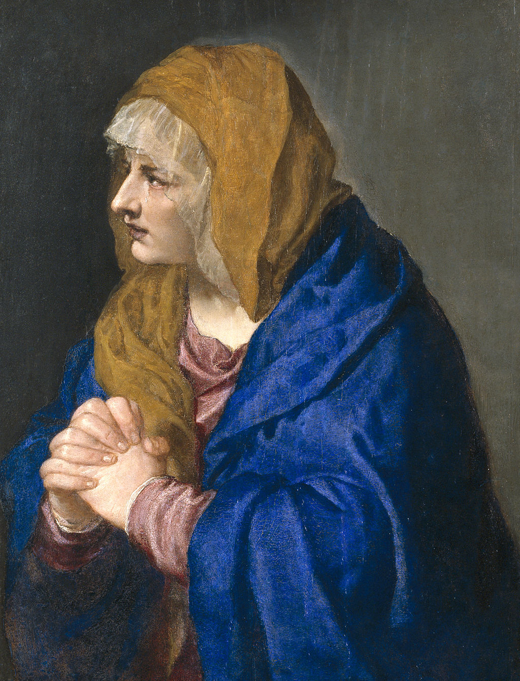 Portrait of a woman with a yellow headscarf and blue cloak against a dark background. Mater Dolorosa with Clasped Hands by Titian - Religious Art Reproduction