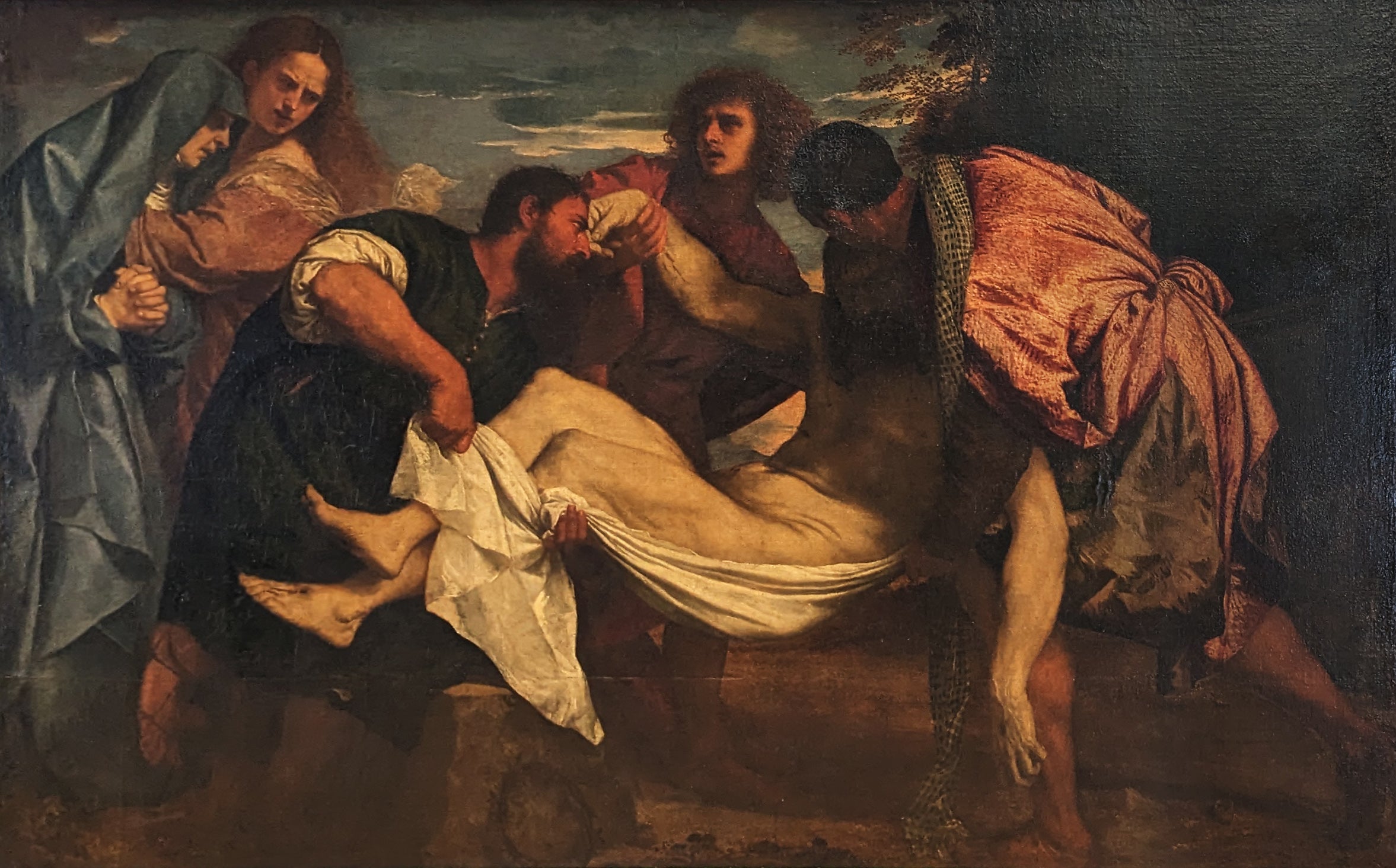 Painting of a group of people surrounding a central figure on a stretcher. The Entombment of Christ by Titian | Louvre Museum Paris
