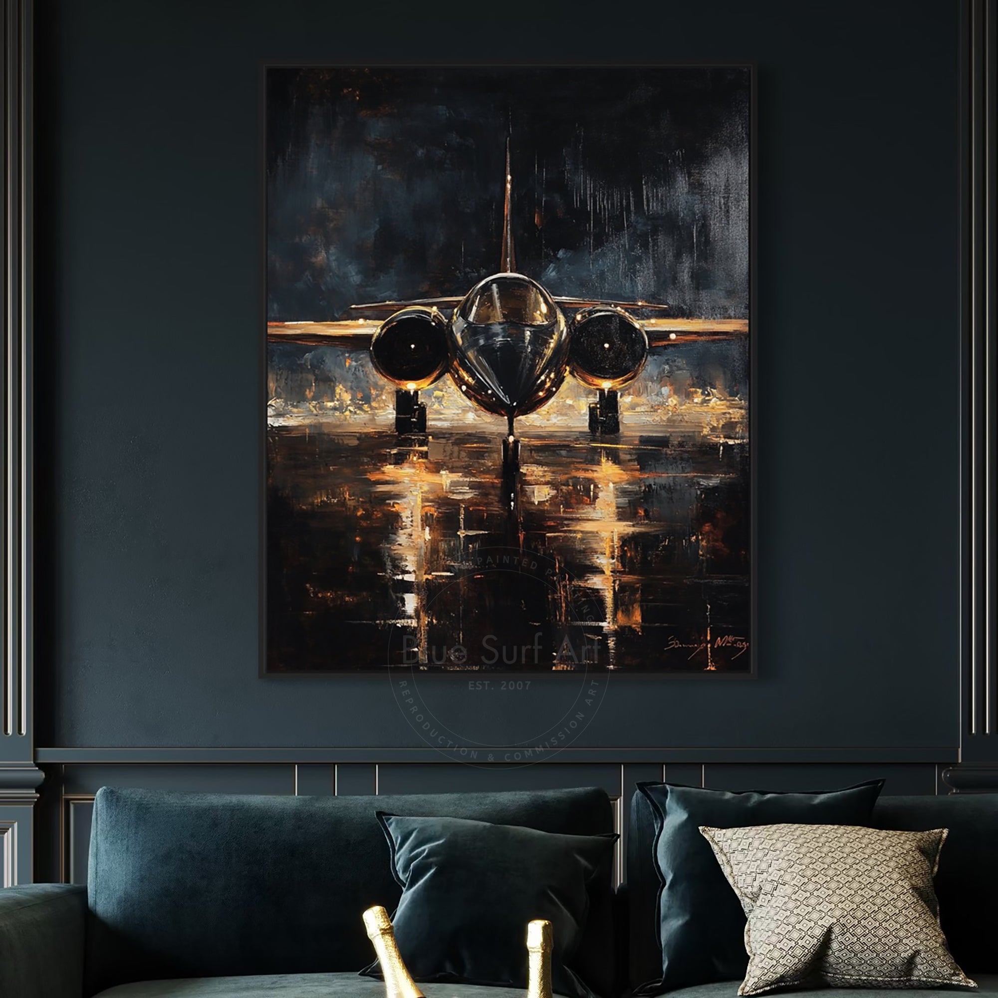 Framed painting of an airplane on a dark wall above a sofa with decorative pillows.