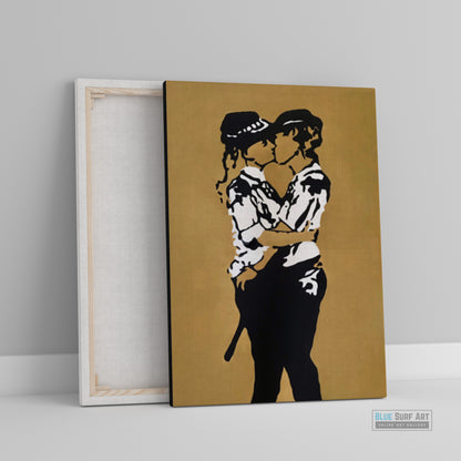 Framed artwork of two people embracing on a gold background.  Iconic Kissing Coppers Reproduction Hand-Painted Oil on Canvas