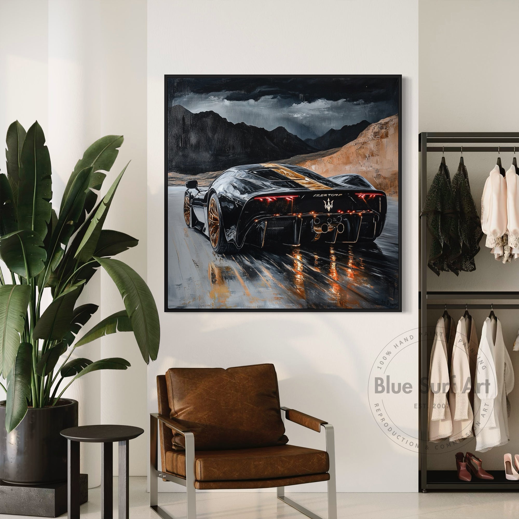 Framed artwork of a black sports car on a mountain road in a modern interior setting.