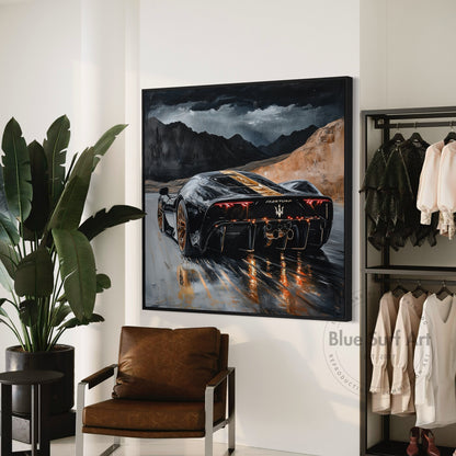 Framed artwork of a car on a wall in a room with a plant, chair, and clothing rack.