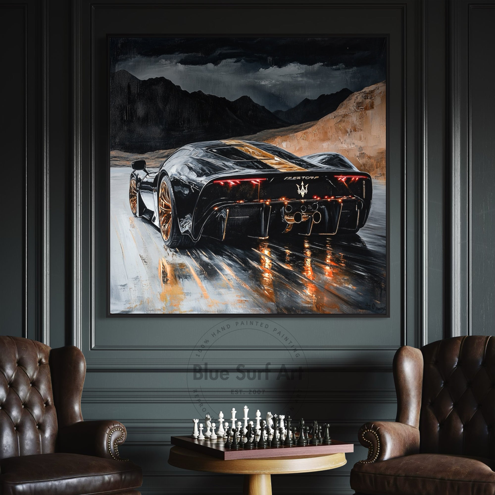 Framed painting of a sports car on a mountain road in a room with brown leather chairs and a chessboard.