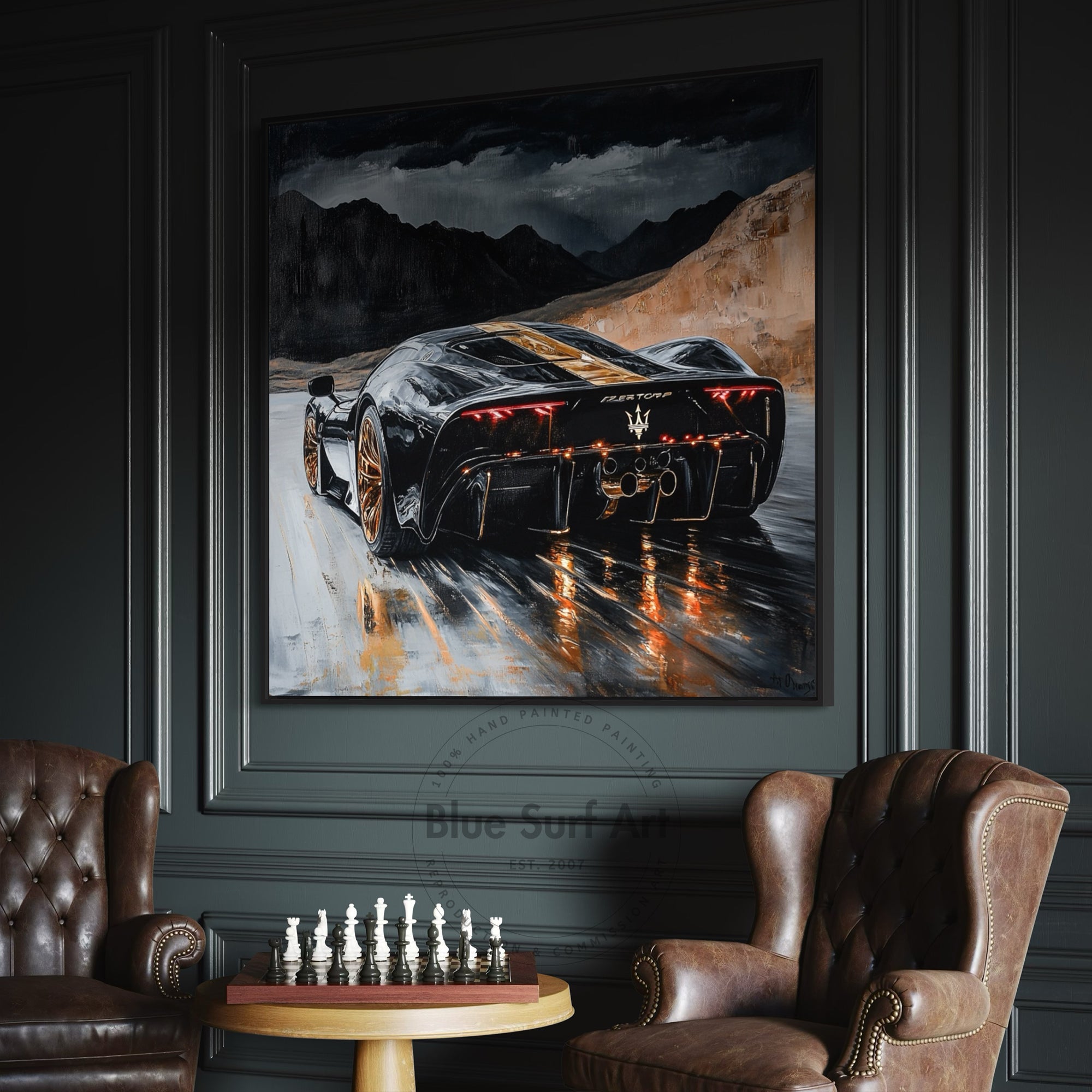 Framed painting of a sports car on a mountain road in a room with leather chairs and a chessboard.